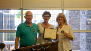 President John presents the "Distinguished Club" certificate for 2015 to Past President Pat and Secretary Val.